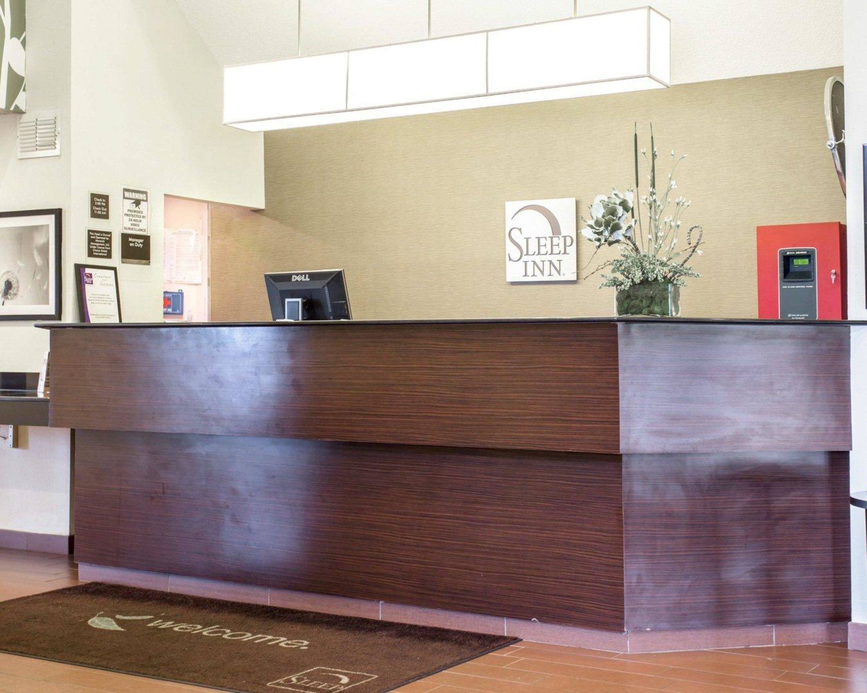 A reception desk with a sign reading "Sleep Inn."