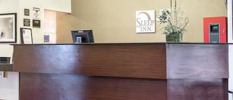 A reception desk with a sign reading "Sleep Inn."