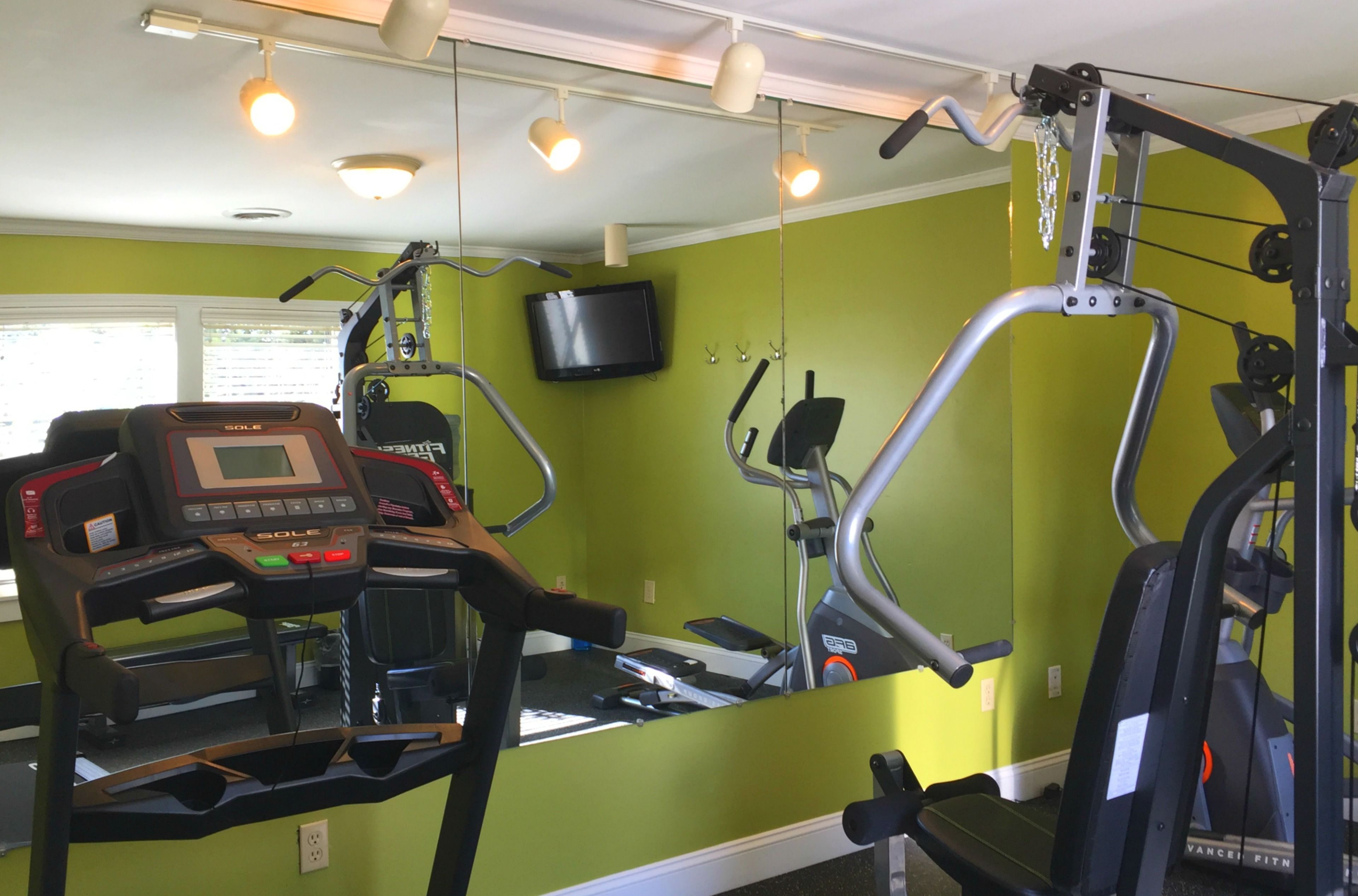 A gym with treadmills, a stationary bike, and a weight machine.