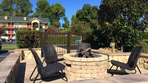 A patio area with stone seating and a fire pit.