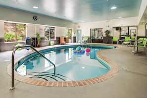 An indoor swimming pool with a clear water surface, surrounded by a tiled deck and a brick border. - Holiday Inn Express Dublin by IHG (Dublin)