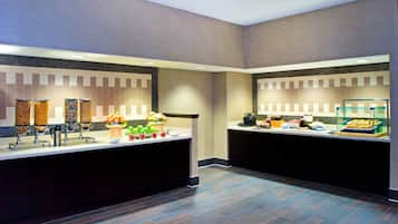 A modern breakfast bar with a variety of food items and a coffee station.