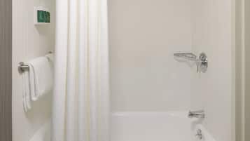 A bathroom with a bathtub, a shower curtain, and a towel rack.