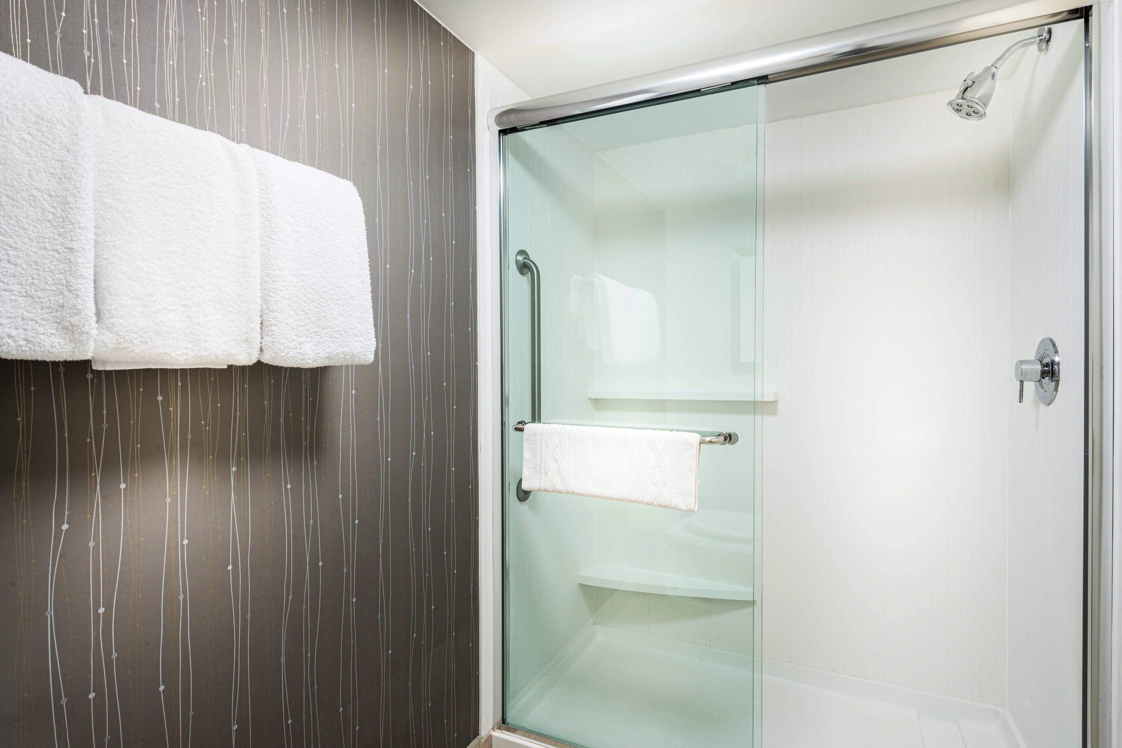 designer toiletries, hair dryer, towels