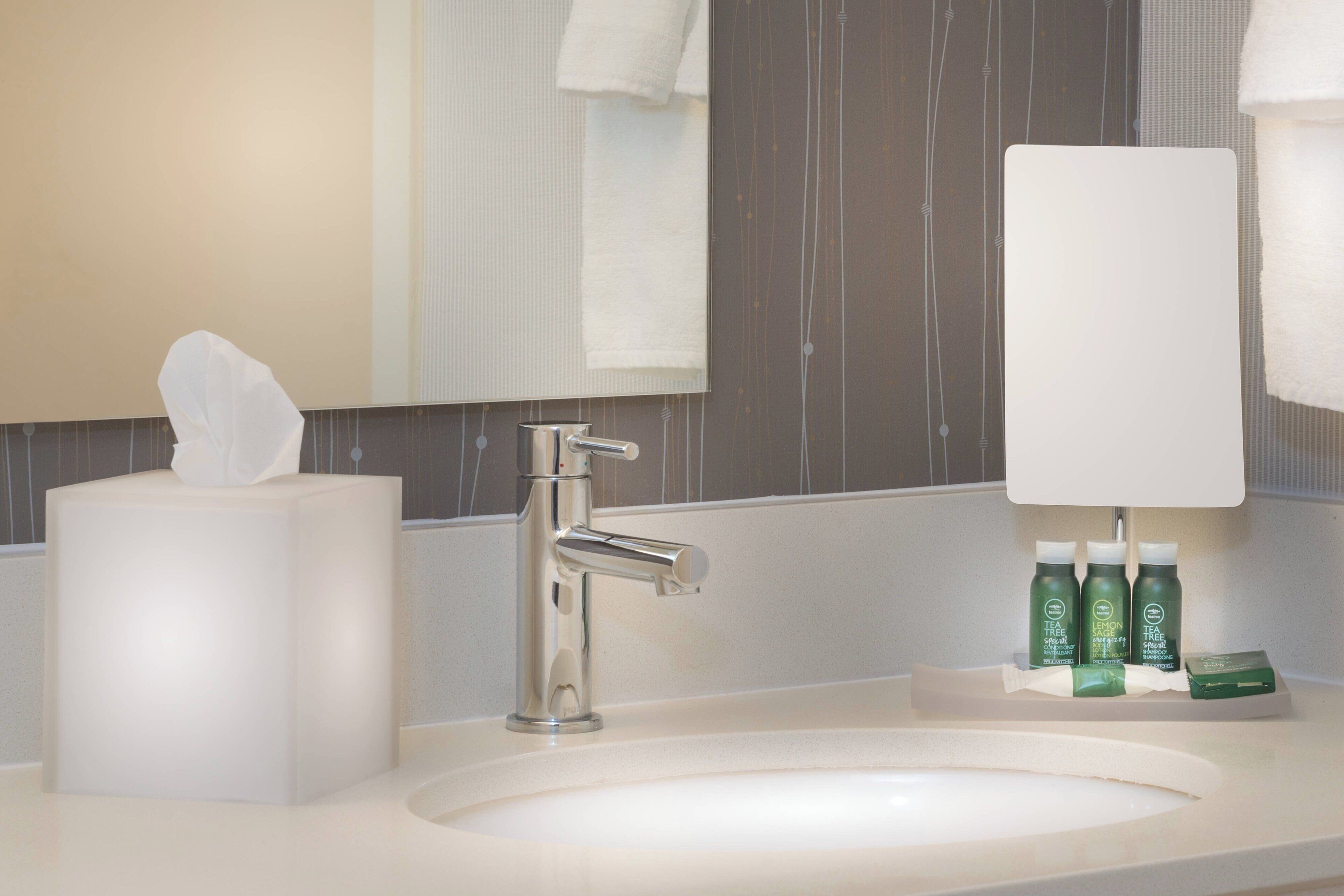 designer toiletries, hair dryer, towels