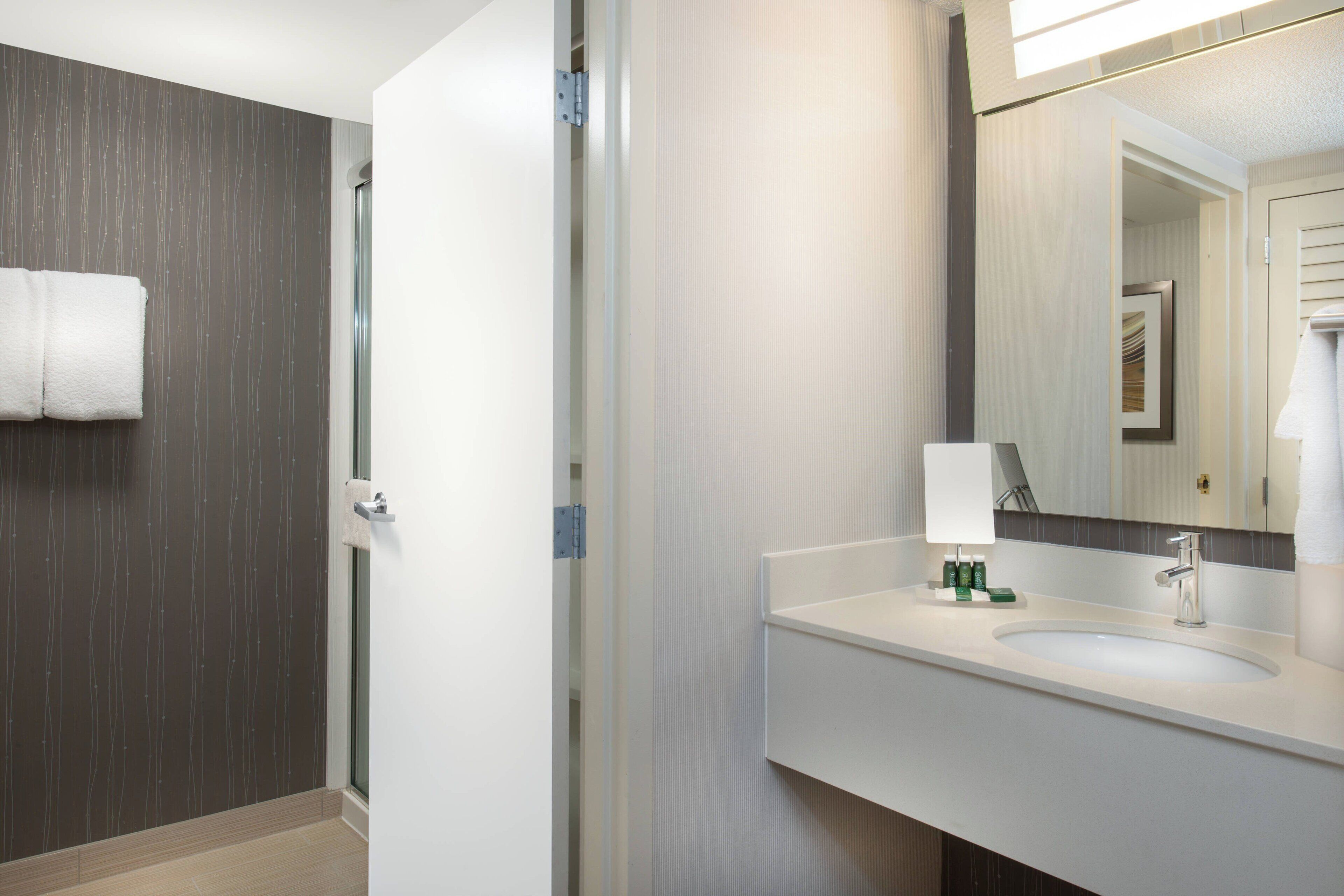 designer toiletries, hair dryer, towels