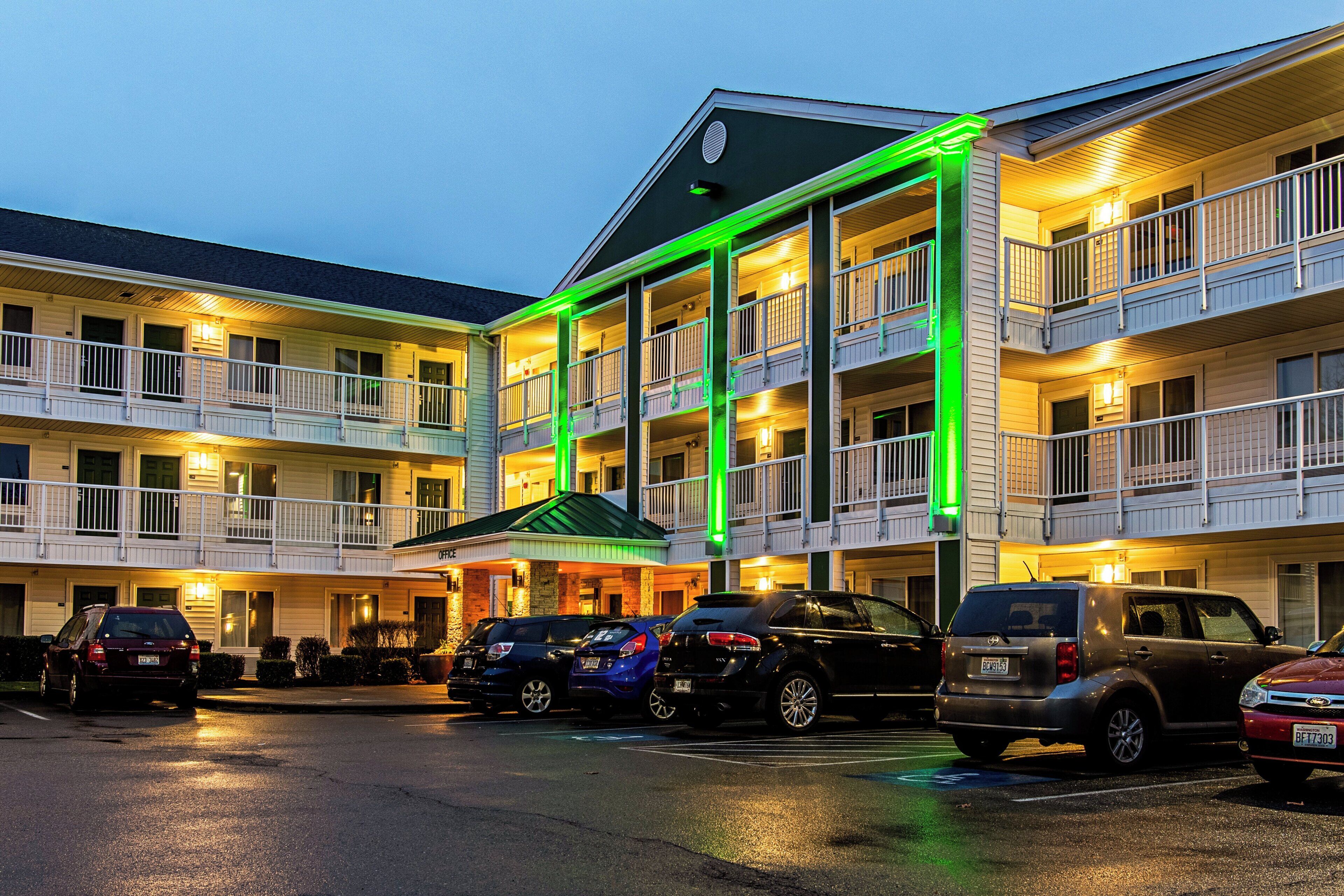 Ein mehrstöckiges Hotel mit Parkplatz.