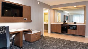 A hotel room with a desk, chair, TV, kitchenette, and a bathroom visible through an open door. - Courtyard by Marriott Livermore (Livermore)