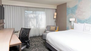 A hotel room with a large bed, a desk, a chair, and a TV. - Courtyard by Marriott Livermore (Livermore)