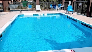 A rectangular swimming pool with clear blue water, surrounded by a tiled deck. There are several lounge chairs and a fence with a 'No Diving' sign. - Quality Inn & Suites Thomasville-High Point (Thomasville)