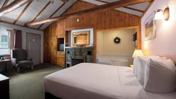 Deluxe Jacuzzi Queen with Fireplace | Blackout drapes, iron/ironing board, travel crib, free rollaway beds