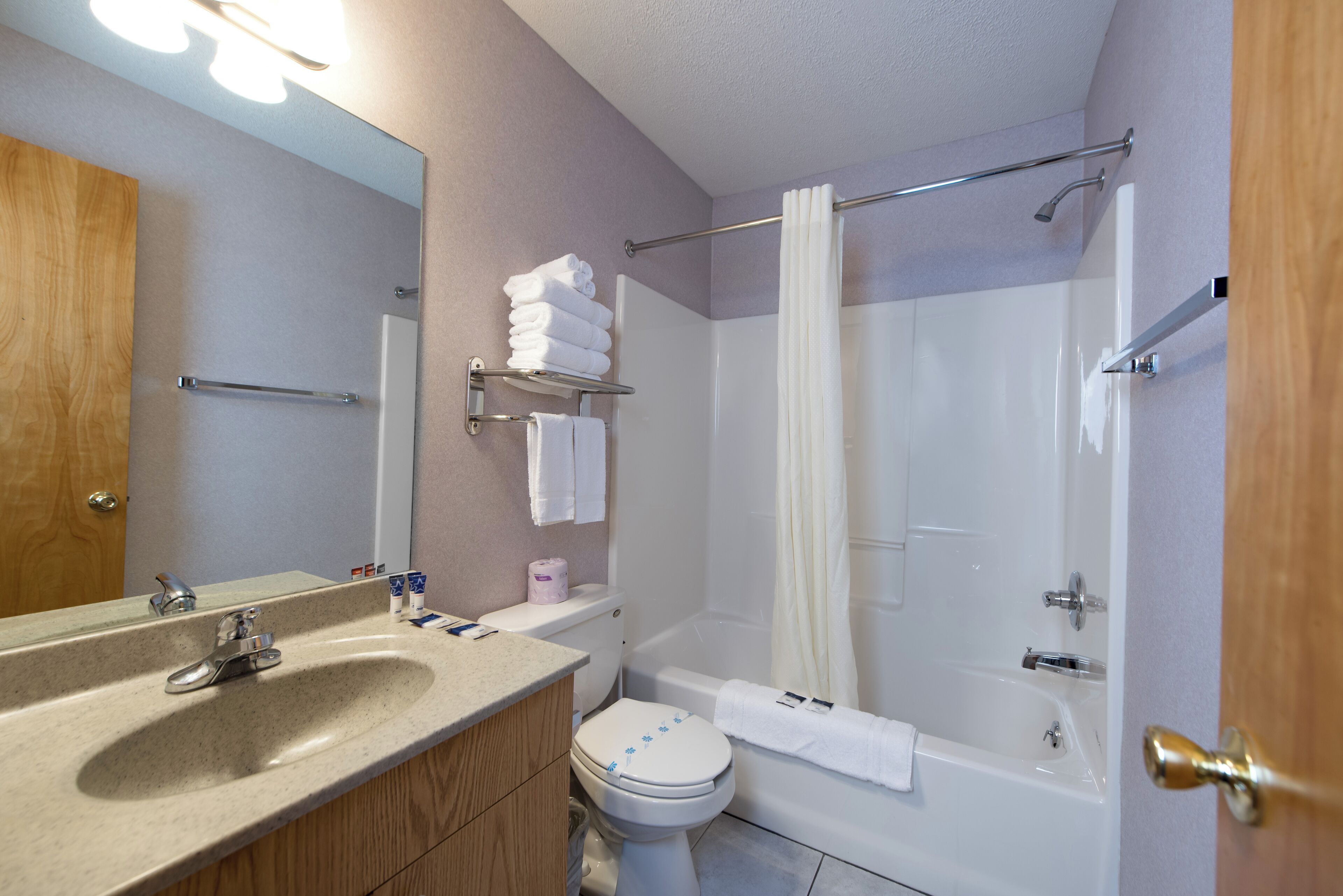 A bathroom with a sink, toilet, and bathtub.