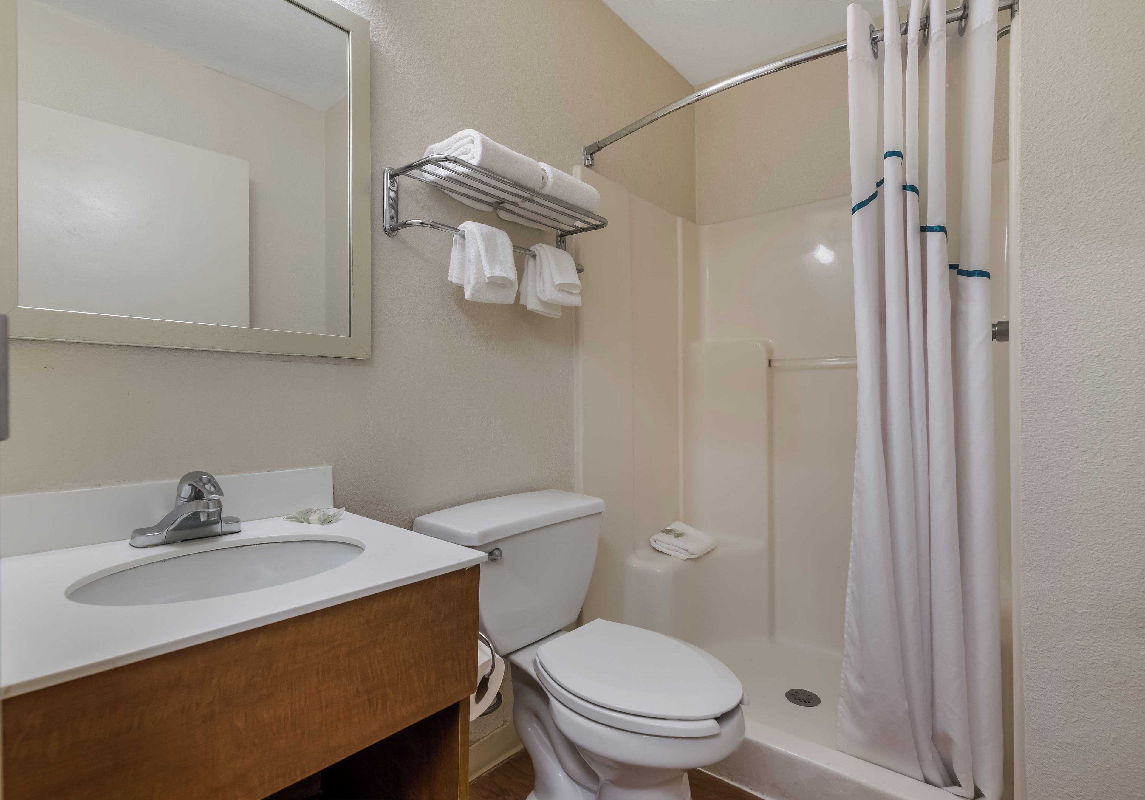 A bathroom with a sink, toilet, and shower.