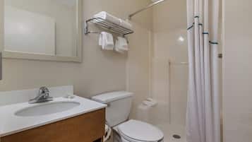 A bathroom with a sink, toilet, and shower.