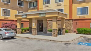 A hotel entrance with a lobby area, numbered 20, and a parking space marked with a wheelchair accessibility symbol. - Extended Stay America Suites Jacksonville Camp Lejeune (Jacksonville)