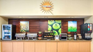 A breakfast bar with a coffee machine, toaster, and food dispensers.