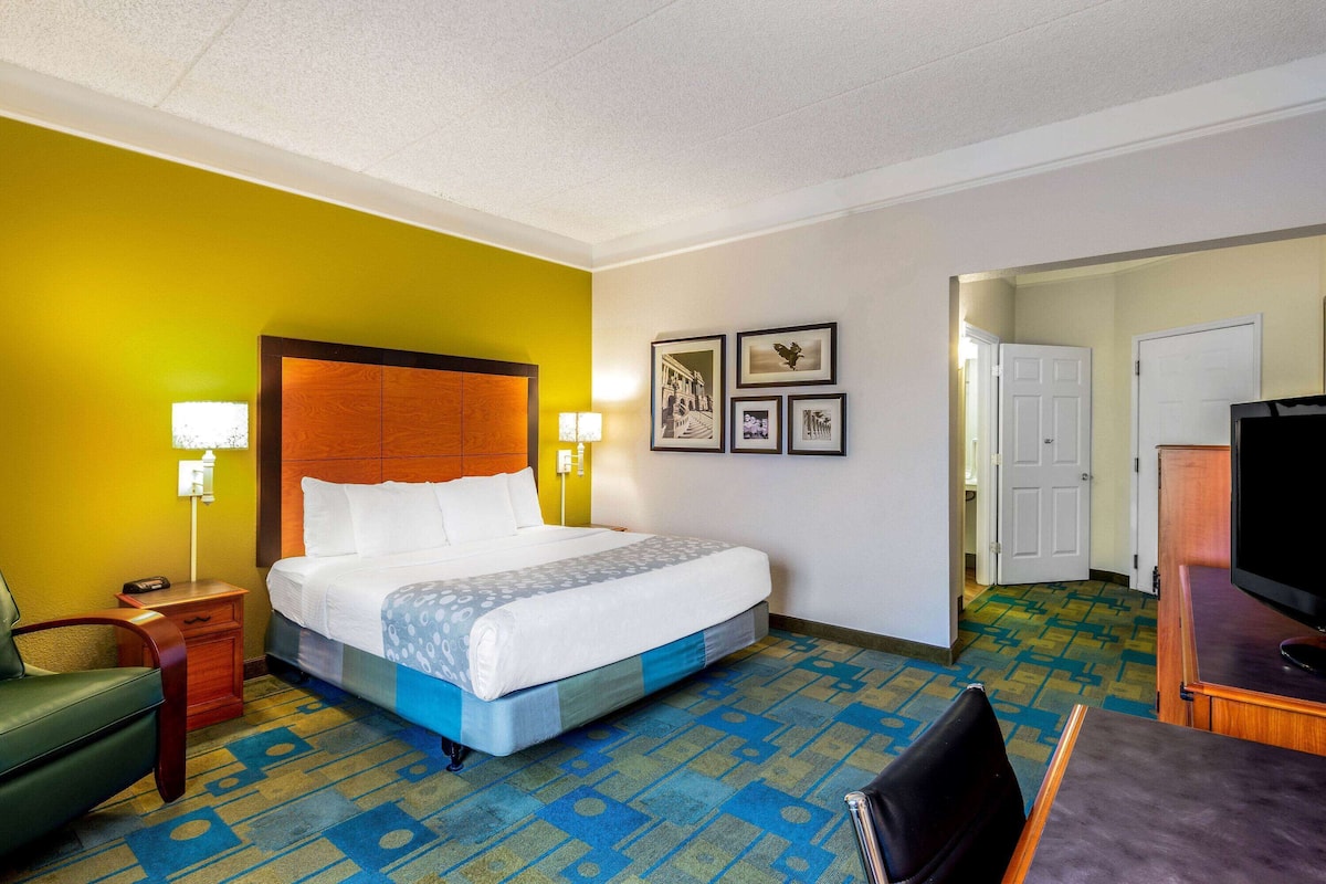 Premium bedding, desk, laptop workspace, blackout drapes