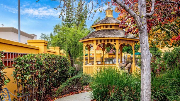 A gazebo with a tiled roof, surrounded by a garden with a pathway leading to it. - La Quinta Inn & Suites by Wyndham Fremont / Silicon Valley (Fremont)