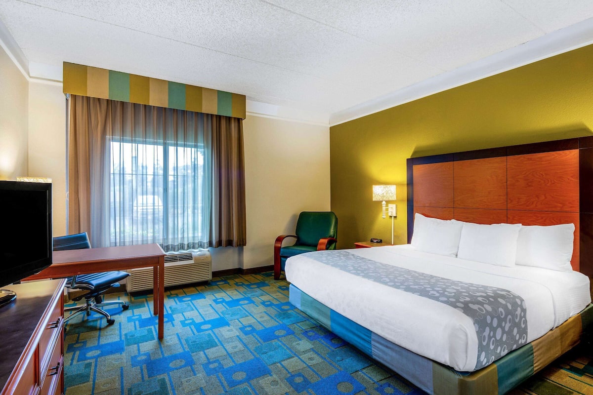 Premium bedding, desk, laptop workspace, blackout drapes