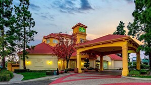 A hotel with a red-tiled roof, a prominent 'La Quinta' sign, and a covered entrance area. - La Quinta Inn & Suites by Wyndham Fremont / Silicon Valley (Fremont)