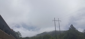 Surrounded by lush greenery, this serene mountain landscape offers breathtaking views.