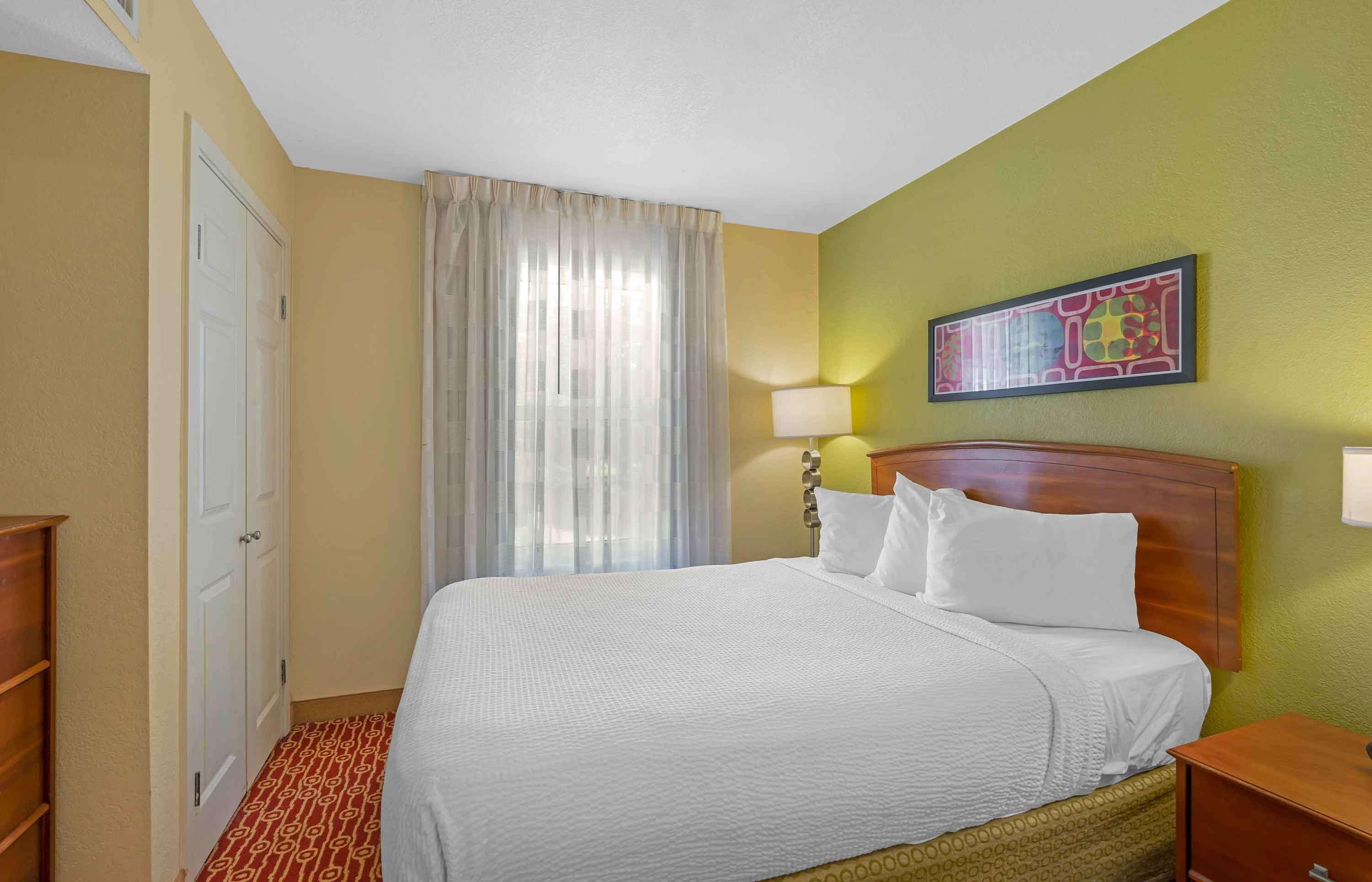 Premium bedding, desk, laptop workspace, blackout drapes