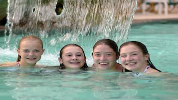 Relax by the pool with a soothing waterfall and comfortable lounge seating.