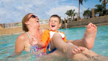 A woman and a child in a swimming pool.