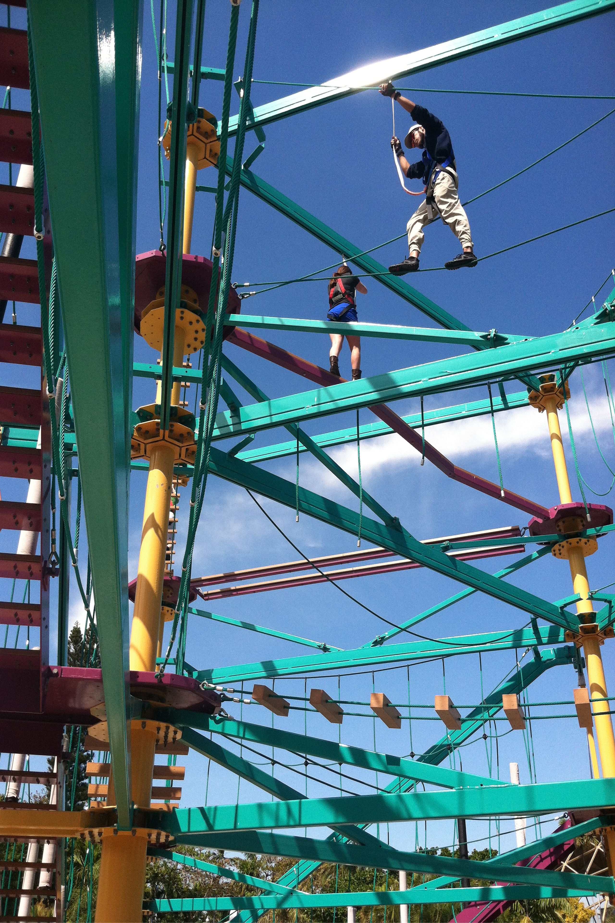 A rope bridge structure with multiple levels and platforms, designed for walking or climbing.