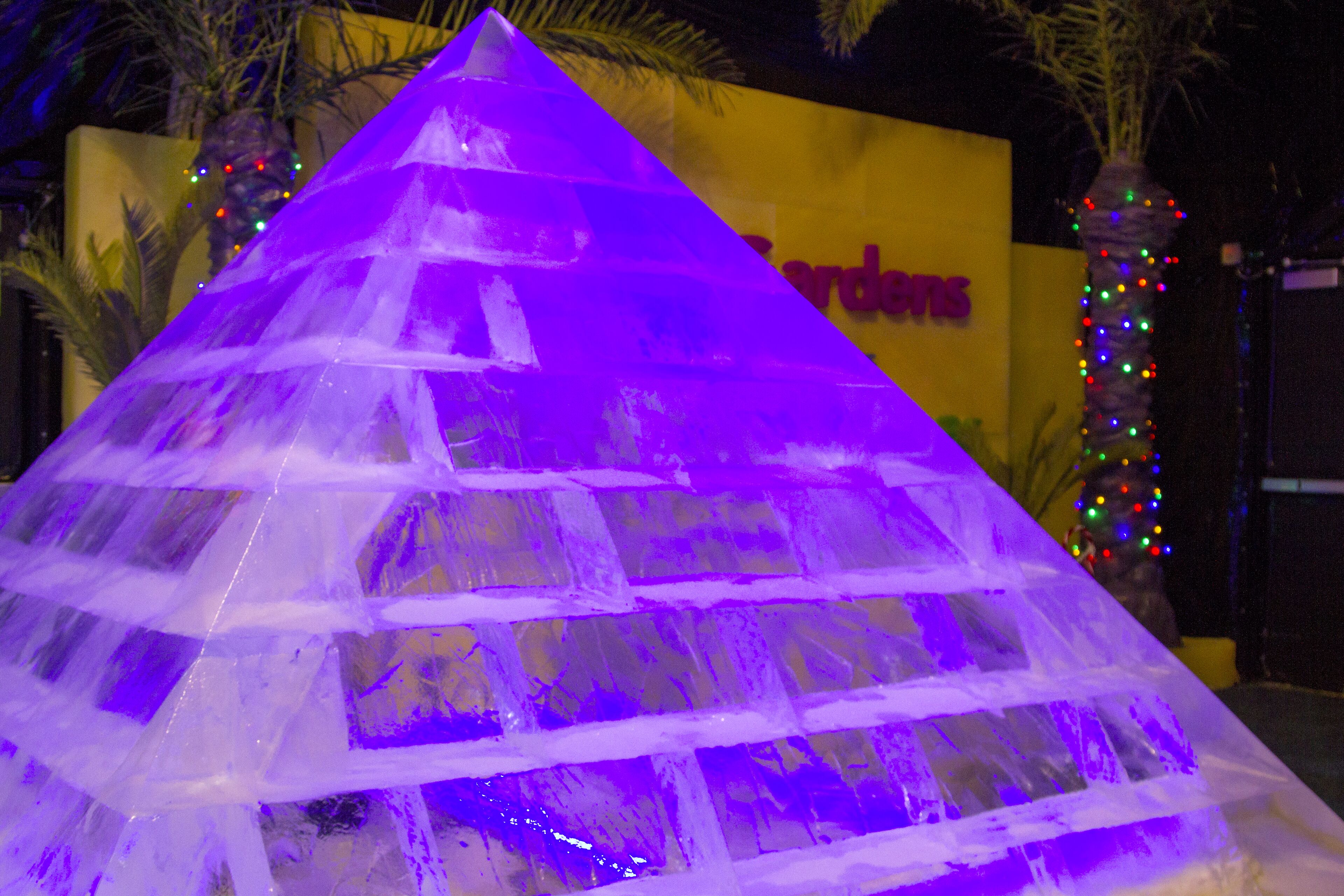 A pyramid-shaped structure with a yellow background and the word "Gardens" visible.