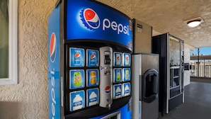 A Pepsi vending machine with various drink options and a water dispenser. - Rodeway Inn San Bernardino - Colton (San Bernardino)
