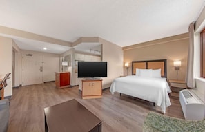 A hotel room with a bed, TV, desk, and kitchenette. - Extended Stay America Suites Ft Lauderdale Cyp Crk NW 6th Wy (Fort Lauderdale)
