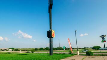 A roadside sign with a Super 8 logo, a Dixie diner sign, and a gas price sign.