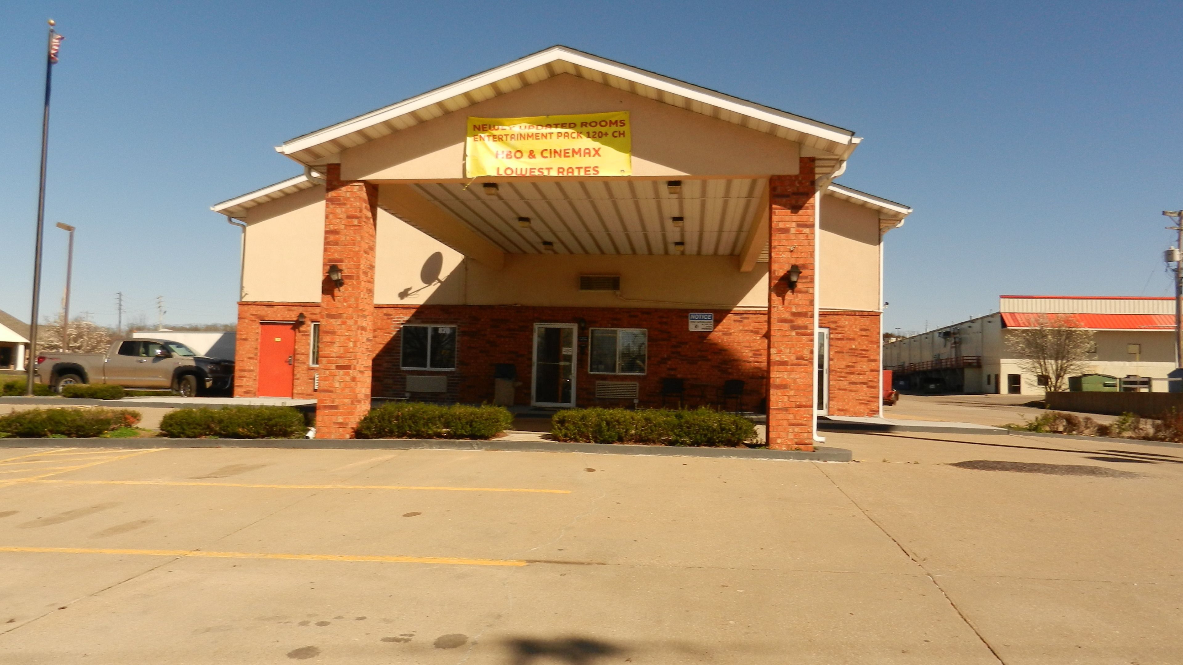 A building with a sign advertising updated rooms and entertainment options.