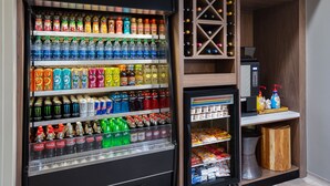 A vending machine stocked with various beverages and snacks, including Dasani water, Monster energy drinks, and Doritos. - Hilton Garden Inn Albuquerque North/Rio Rancho (Rio Rancho)