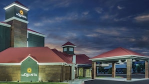 A La Quinta hotel with a prominent entrance, a tower, and a covered area.