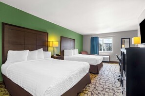 A hotel room with two beds, a desk, a chair, a TV, and a window with curtains. - SureStay Plus Hotel by Best Western Bettendorf (Bettendorf)