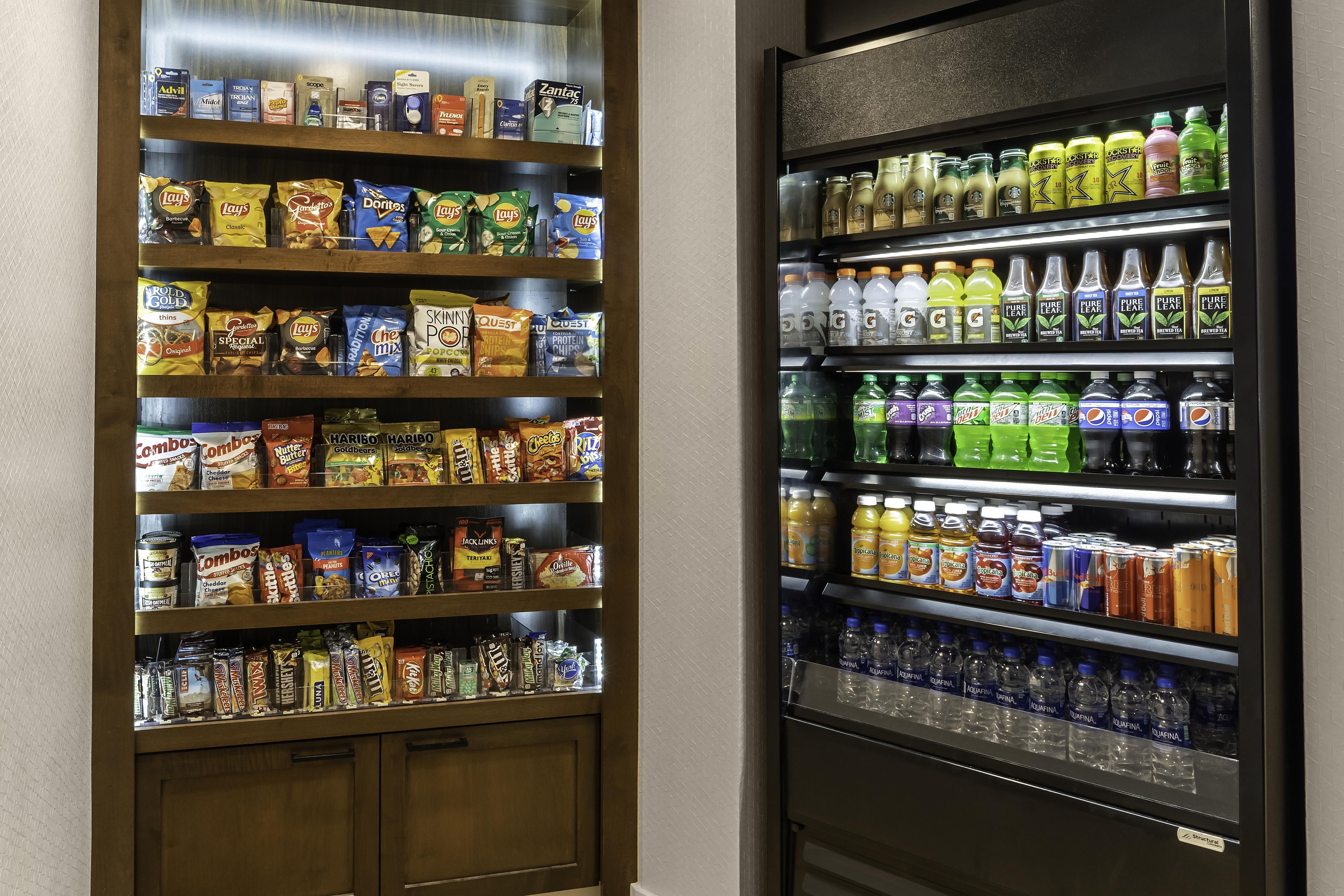 A snack vending machine stocked with various chips and a beverage dispenser with multiple drink options.