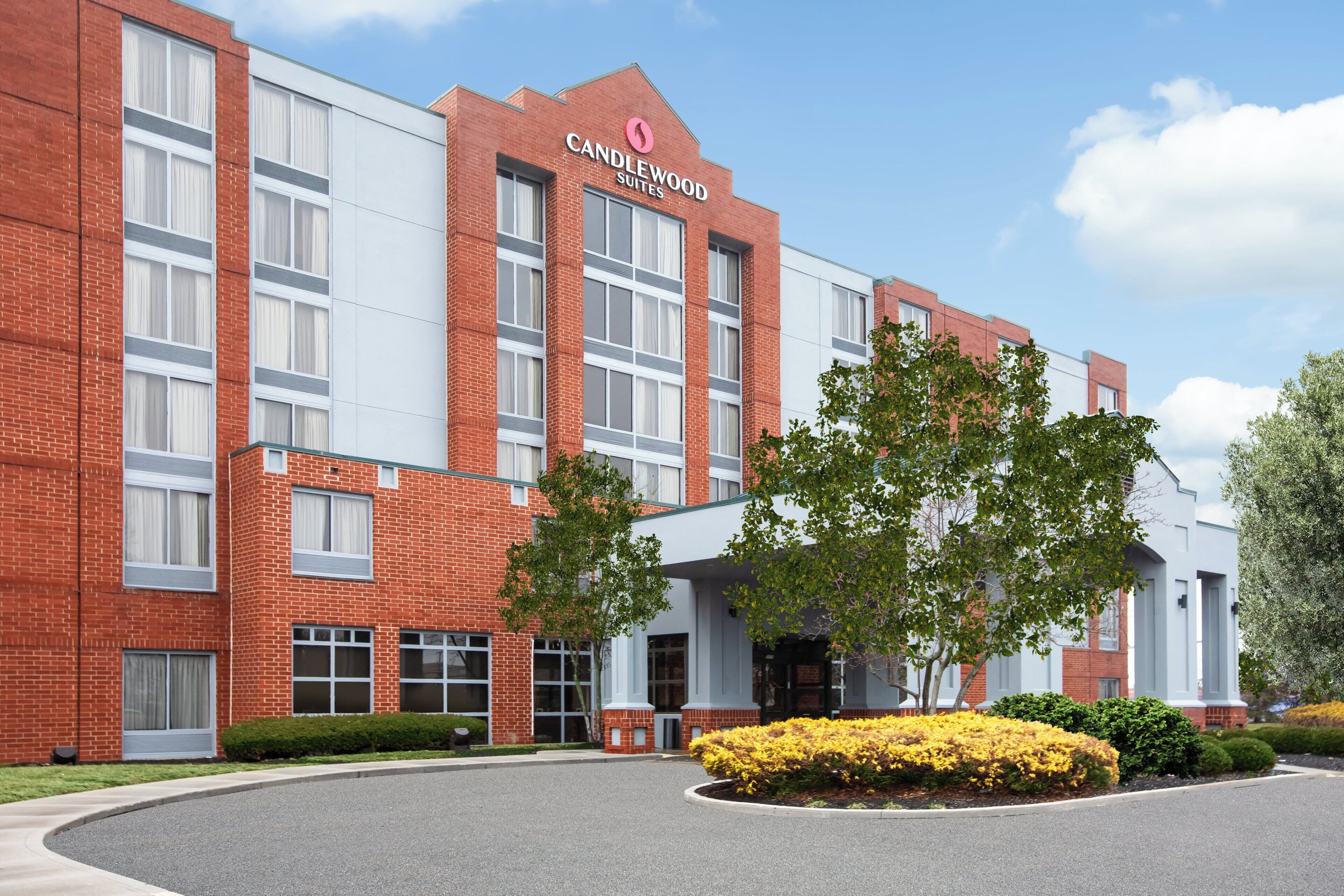 A brick building with a sign reading 'Candlewood Suites.'