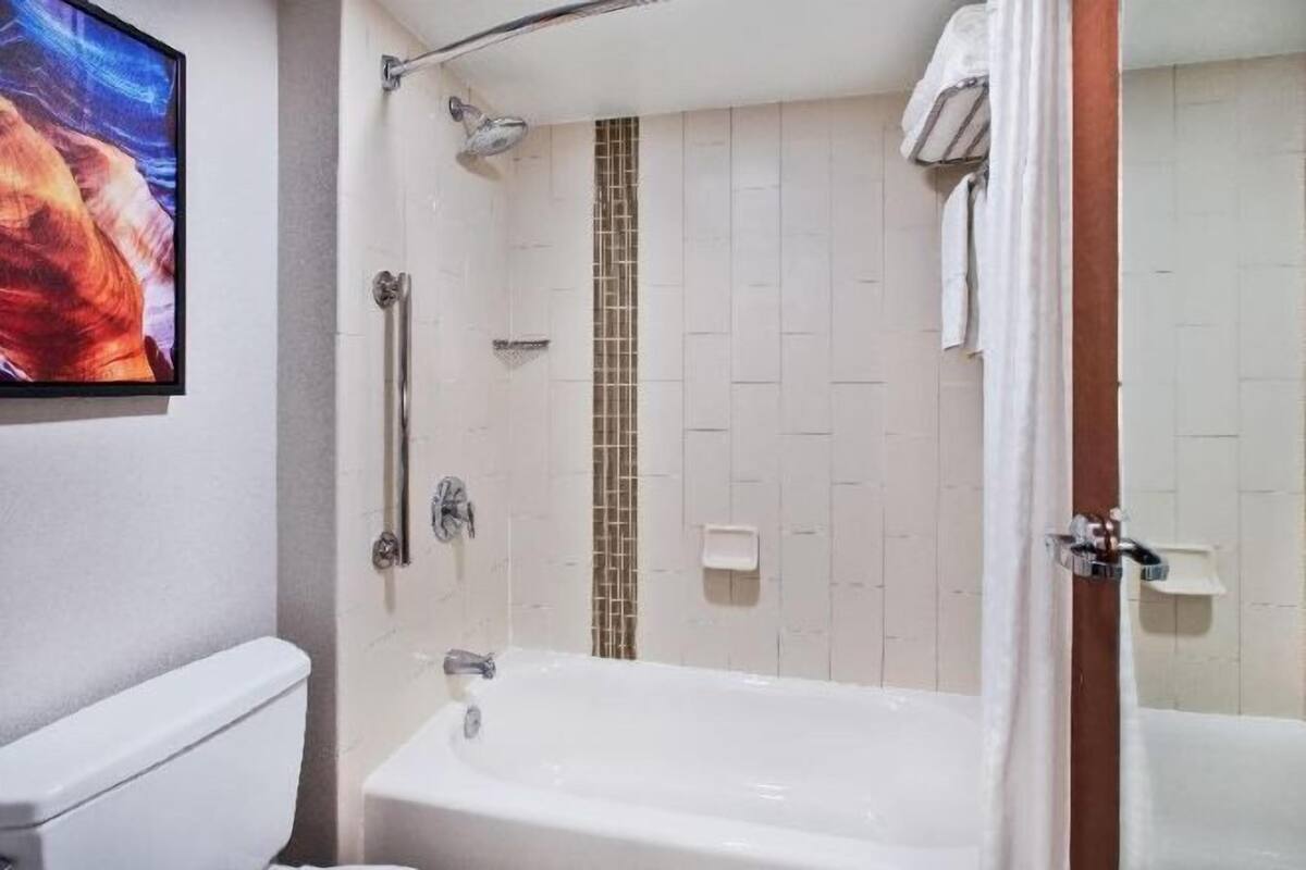 Bathroom | Combined shower/bathtub, designer toiletries, hair dryer, towels