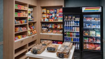 A grocery store with shelves stocked with snacks, beverages, and boxed goods.