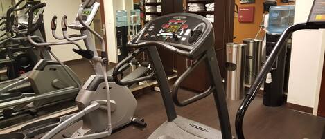 A gym with multiple treadmills and exercise equipment.