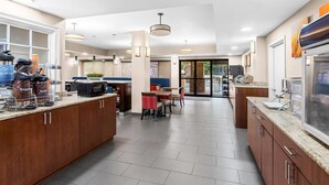 A modern kitchen with a central island, built-in microwave, and coffee station. - Comfort Suites Daphne - Mobile East Bay (Daphne)