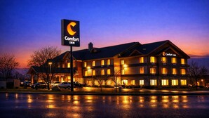 A Comfort Inn hotel with a large sign, multiple windows, and a parking lot. - Comfort Inn Owatonna near Medical Center (Owatonna)