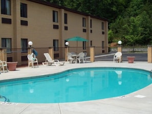 Seasonal outdoor pool, open 9:00 AM to 10:00 PM, pool loungers