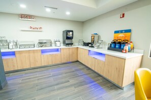 A coffee station with multiple coffee machines and a sign that reads 'Rise & Shine'. - Comfort Inn Mission - McAllen West (Mission)
