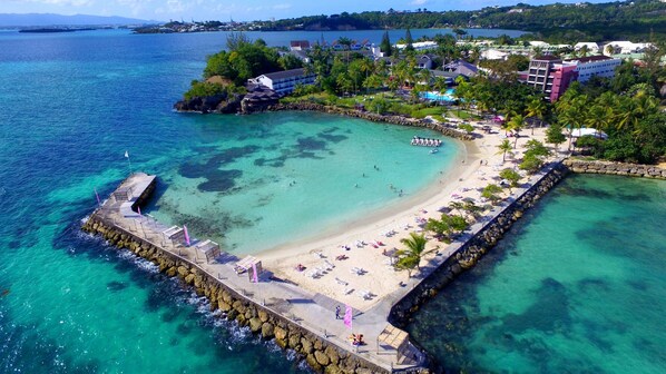 On the beach, white sand, sun loungers, beach umbrellas