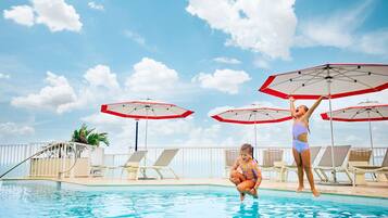 Relax by the pool with comfortable lounge chairs and shaded areas.