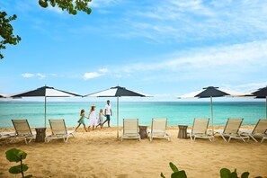 On the beach, white sand, beach cabanas, beach towels