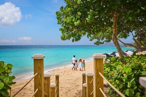 On the beach, white sand, beach cabanas, beach towels